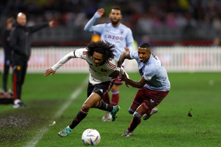 Aston Villa's Ashley Young battles with Tahith Chong