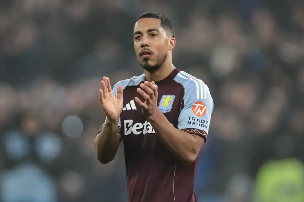 Youri Tielemans holds his leg with injury concern during World Cup action