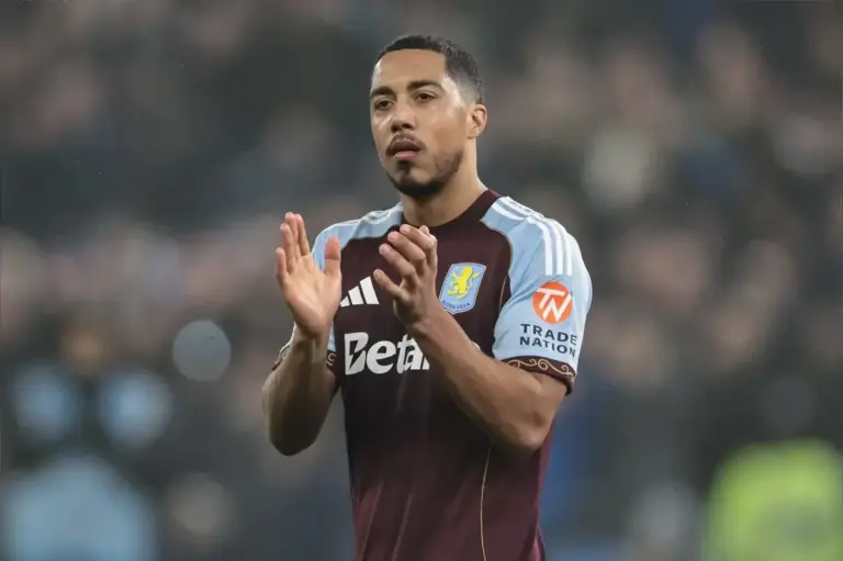 Youri Tielemans holds his leg with injury concern during World Cup action